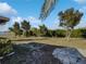 Landscaped backyard with firepit and flagstone patio at 7207 Summit Pl, Winter Haven, FL 33884