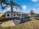 Home's backyard features a stone patio and screened enclosure at 7207 Summit Pl, Winter Haven, FL 33884