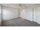 Simple bedroom with neutral walls and carpet, and access to a bathroom at 7207 Summit Pl, Winter Haven, FL 33884