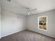 Well-lit bedroom featuring a ceiling fan and window view at 7207 Summit Pl, Winter Haven, FL 33884