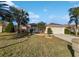 House exterior showcases a well-maintained lawn and a two-car garage at 7207 Summit Pl, Winter Haven, FL 33884