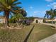 Landscaped front yard with mature palm trees enhances curb appeal at 7207 Summit Pl, Winter Haven, FL 33884