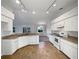 White kitchen with tile floors and track lighting at 7207 Summit Pl, Winter Haven, FL 33884