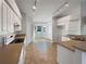 White kitchen with tile floors and track lighting, breakfast nook area at 7207 Summit Pl, Winter Haven, FL 33884