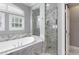 Luxurious bathroom with stand alone tub and glass shower with marble tiling at 7613 Debeaubien Dr, Orlando, FL 32835