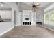 Bright living room with a fireplace, built in shelving, and hardwood floors at 7613 Debeaubien Dr, Orlando, FL 32835