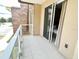 Private balcony with glass railings overlooking a parking area at 7638 Recife Dr, Kissimmee, FL 34747