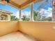 Spacious balcony with white columns and a view of lush tropical landscape at 8451 Leatherleaf Ln, Orlando, FL 32827