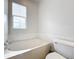 Bathroom with bathtub and toilet at 8451 Leatherleaf Ln, Orlando, FL 32827