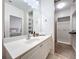 Bright bathroom with double vanity, large mirror, and walk-in closet at 8451 Leatherleaf Ln, Orlando, FL 32827