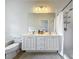Bathroom with double vanity, shower, and toilet at 8451 Leatherleaf Ln, Orlando, FL 32827