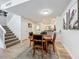 Charming dining area with a wooden table and four chairs, adjacent to the kitchen at 8451 Leatherleaf Ln, Orlando, FL 32827