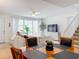 Dining area with a square wooden table and four black chairs at 8451 Leatherleaf Ln, Orlando, FL 32827