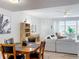 Dining area with wooden table and view of living room and patio at 8451 Leatherleaf Ln, Orlando, FL 32827