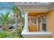 Row of townhouses with balconies, white columns, and lush landscaping at 8451 Leatherleaf Ln, Orlando, FL 32827