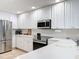 Bright kitchen with white cabinets, stainless steel appliances and tile floor at 8451 Leatherleaf Ln, Orlando, FL 32827