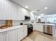 Modern kitchen with white cabinets and stainless steel appliances at 8451 Leatherleaf Ln, Orlando, FL 32827
