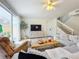 Open living space showcasing a cozy seating arrangement and a staircase leading upstairs at 8451 Leatherleaf Ln, Orlando, FL 32827