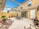 Outdoor patio with covered seating and fire pit at 8451 Leatherleaf Ln, Orlando, FL 32827