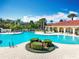 Community pool with lounge chairs and surrounding landscaping at 8451 Leatherleaf Ln, Orlando, FL 32827