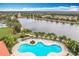 Aerial view of resort-style pool with lake view at 8451 Leatherleaf Ln, Orlando, FL 32827