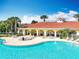 Community pool area with adjacent building and lounge chairs at 8451 Leatherleaf Ln, Orlando, FL 32827