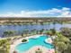 Resort-style pool with lounge chairs and serene lake views at 8451 Leatherleaf Ln, Orlando, FL 32827