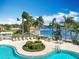 Community pool with lake view and lounge chairs at 8451 Leatherleaf Ln, Orlando, FL 32827