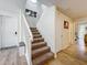 Staircase with carpet runner and light wood flooring at 8451 Leatherleaf Ln, Orlando, FL 32827