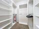 Spacious walk-in closet with ample shelving and hanging space at 8451 Leatherleaf Ln, Orlando, FL 32827