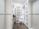 Large walk-in closet with hanging rods and shelving at 8451 Leatherleaf Ln, Orlando, FL 32827