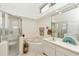 Bright bathroom with a glass-enclosed shower, soaking tub, and large mirror at 8520 Sw 209Th Ct, Dunnellon, FL 34431