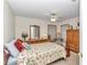 Charming bedroom with a ceiling fan, neutral walls, and plenty of natural light at 8520 Sw 209Th Ct, Dunnellon, FL 34431