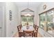 Charming dining room with wood table and six chairs, plus large windows at 8520 Sw 209Th Ct, Dunnellon, FL 34431