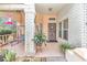 Relaxing front porch with swing, plants, brick columns and a secure front entry door at 8520 Sw 209Th Ct, Dunnellon, FL 34431