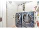 Bright laundry room with modern washer and dryer, built-in cabinets, and plenty of shelving at 8520 Sw 209Th Ct, Dunnellon, FL 34431
