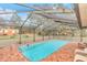 Screened-in pool area with brick deck and comfortable seating at 8520 Sw 209Th Ct, Dunnellon, FL 34431