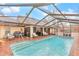 Inviting pool with brick decking and covered lanai for relaxing and entertaining at 8520 Sw 209Th Ct, Dunnellon, FL 34431