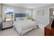 Spacious bedroom with a blue headboard and large windows at 9851 Walkway Dr, Orlando, FL 32832