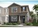 Two-story home with neutral siding, stone accents, and landscaping at 9863 Walkway Dr, Orlando, FL 32832