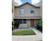 Two-story stucco home with a brown door and landscaping at 1009 Grove St # 90, Maitland, FL 32751