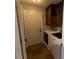Bright laundry room with washer, dryer, and upper cabinets at 1009 Grove St # 90, Maitland, FL 32751