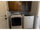 Well-equipped laundry room featuring washer, dryer, and cabinets at 1009 Grove St # 90, Maitland, FL 32751