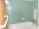 Bathroom with bathtub and light green tile at 1070 N Libby Ct, Daytona Beach, FL 32117