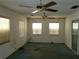 Large bedroom with two windows, ceiling fan, and carpet at 1070 N Libby Ct, Daytona Beach, FL 32117