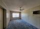 Simple bedroom with wall paneling and window coverings at 1070 N Libby Ct, Daytona Beach, FL 32117