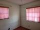 Small bedroom with pink blinds and carpet at 1070 N Libby Ct, Daytona Beach, FL 32117