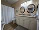 Bathroom with granite countertop and white cabinets at 12021 Villanova Dr # 111, Orlando, FL 32837