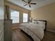 Bedroom with queen bed and ceiling fan at 12021 Villanova Dr # 111, Orlando, FL 32837