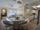 Open dining area with a round glass table and modern chairs at 12021 Villanova Dr # 111, Orlando, FL 32837